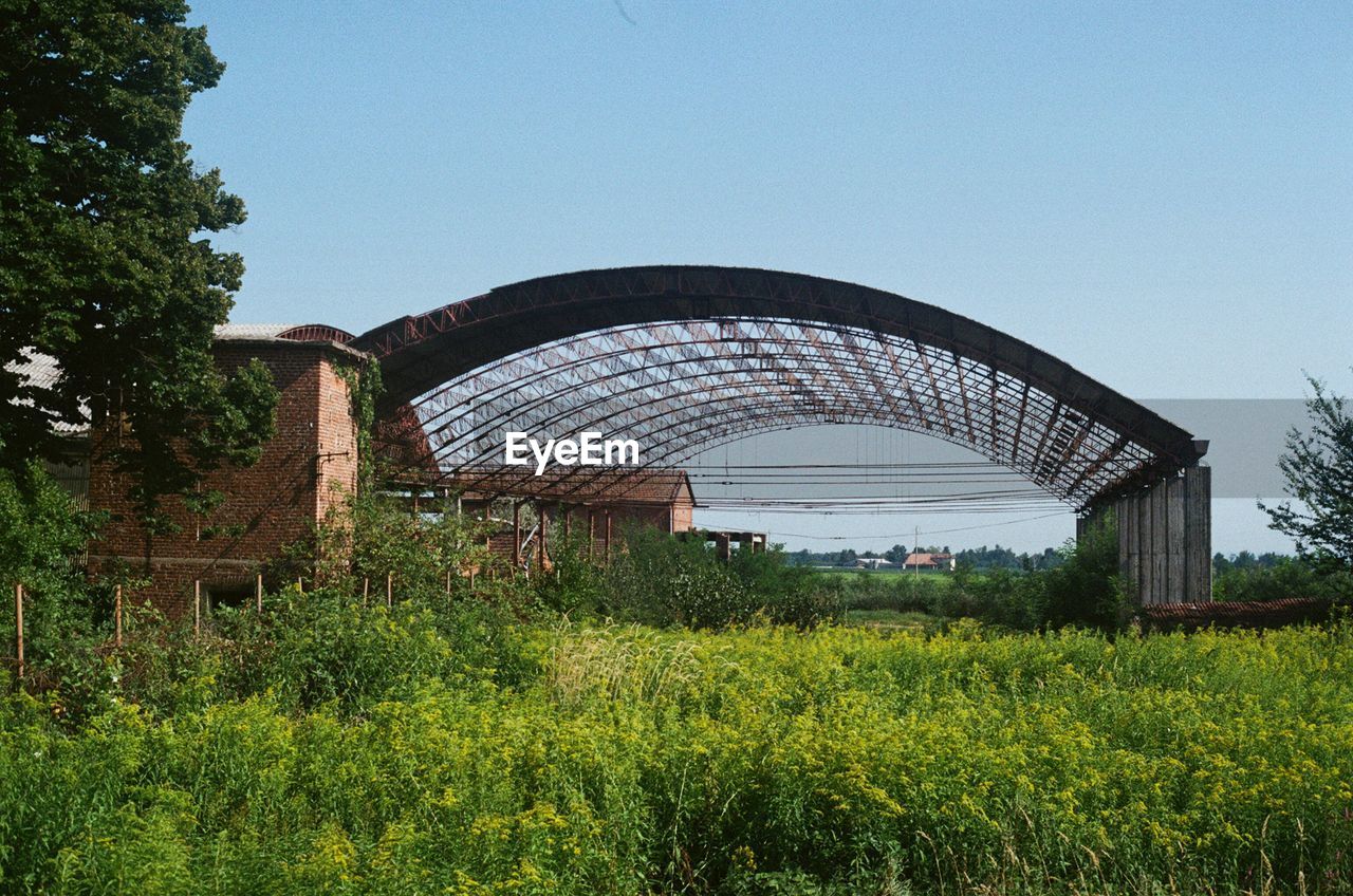 BUILT STRUCTURE ON FIELD AGAINST SKY