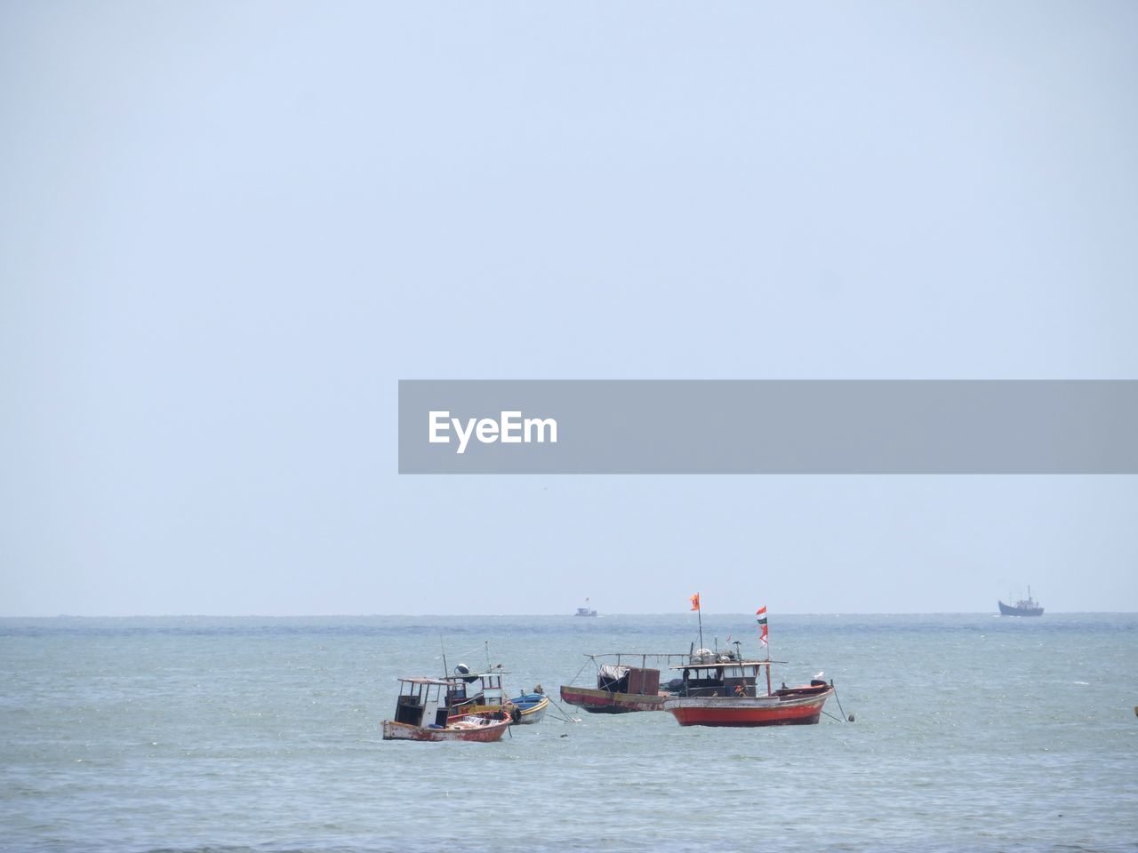 VIEW OF FISHING BOATS IN SEA AGAINST CLEAR SKY