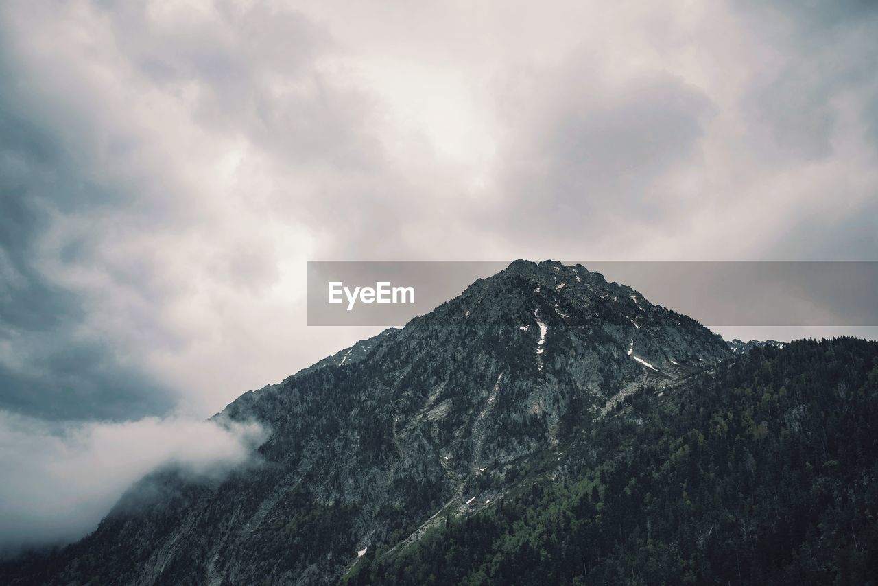 Low angle view of mountain range against sky