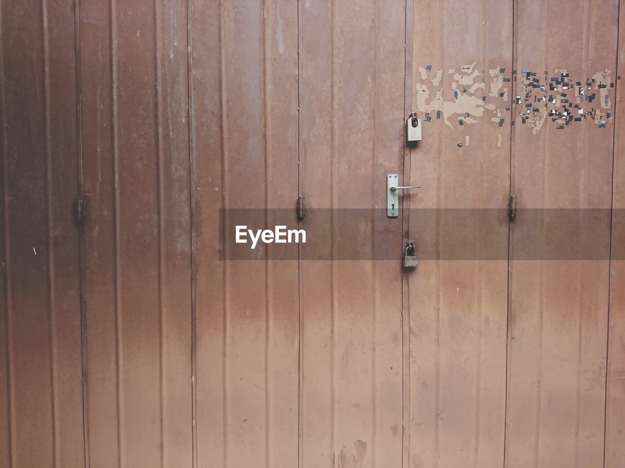 CLOSE-UP OF PADLOCKS ON DOOR