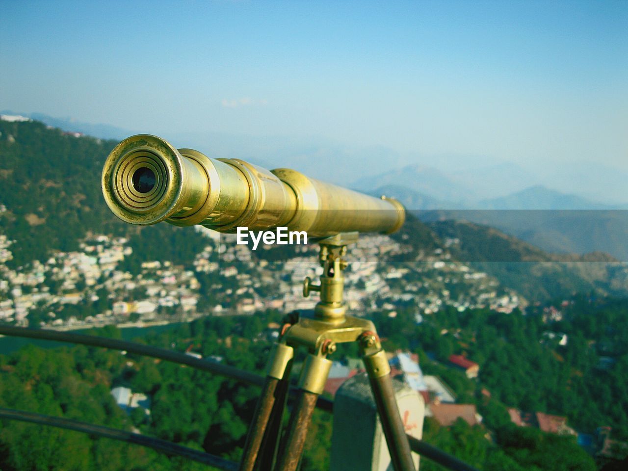 Close-up of old-fashioned metallic binocular over city