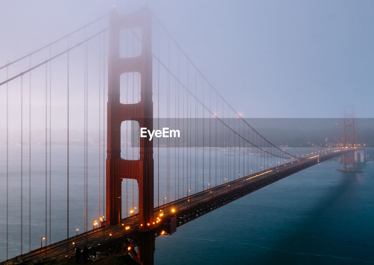 Fog over bridge on river