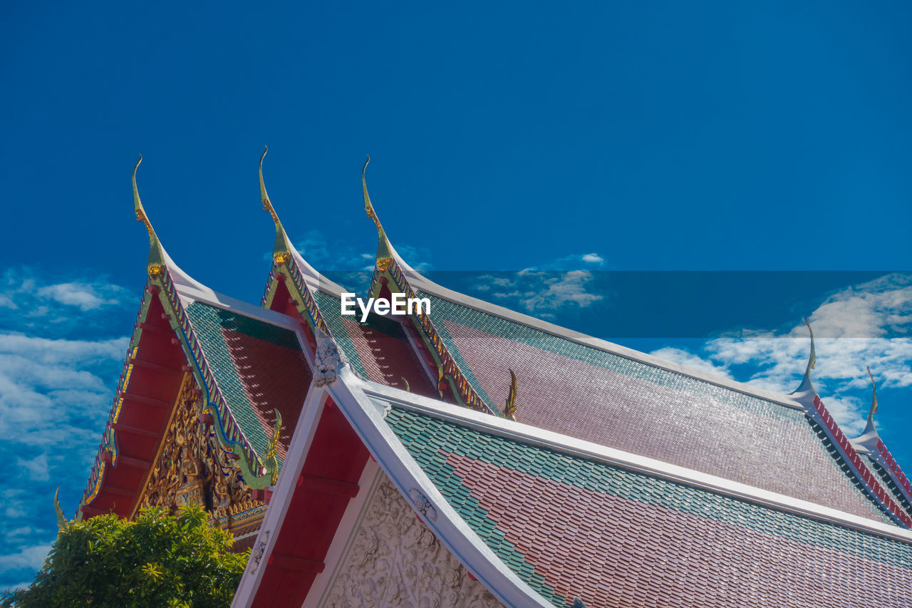 Low angle view of traditional building against blue sky