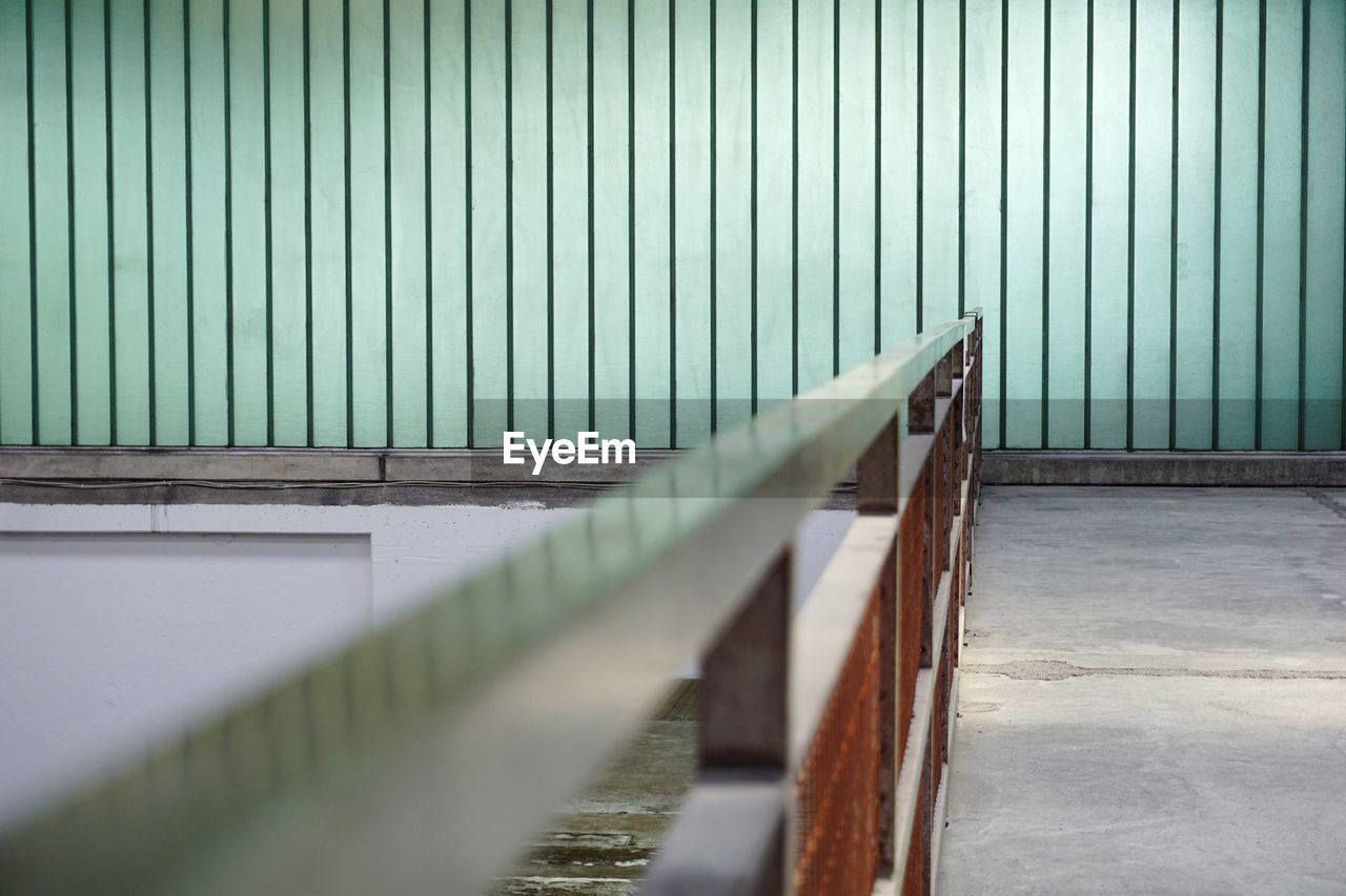 Metal fence against wall