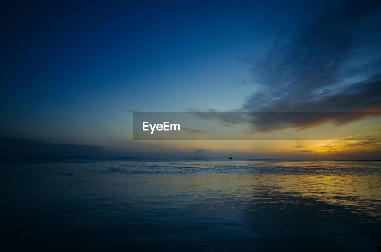 Scenic view of sea against cloudy sky