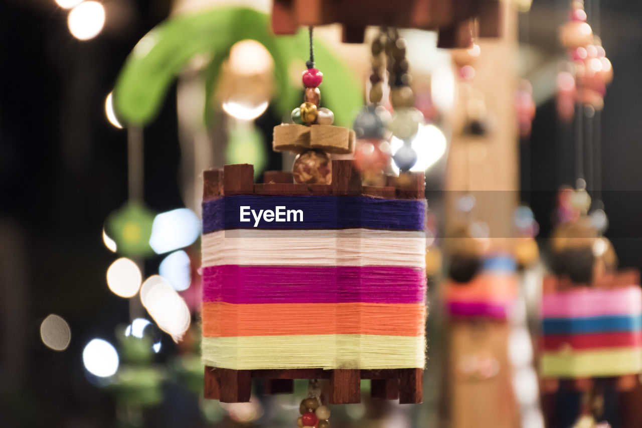 CLOSE-UP OF DECORATIONS HANGING IN MARKET