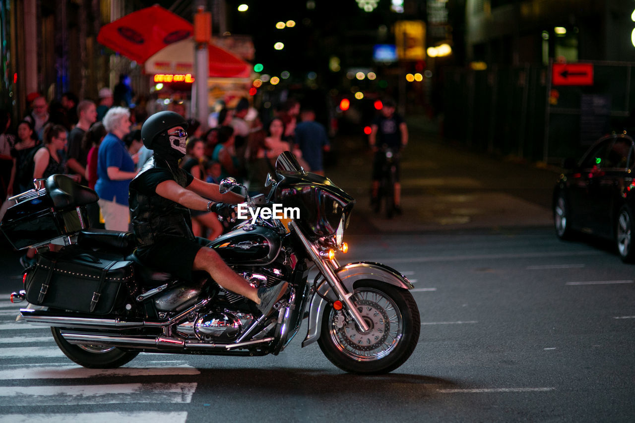 PEOPLE RIDING MOTORCYCLE ON ROAD