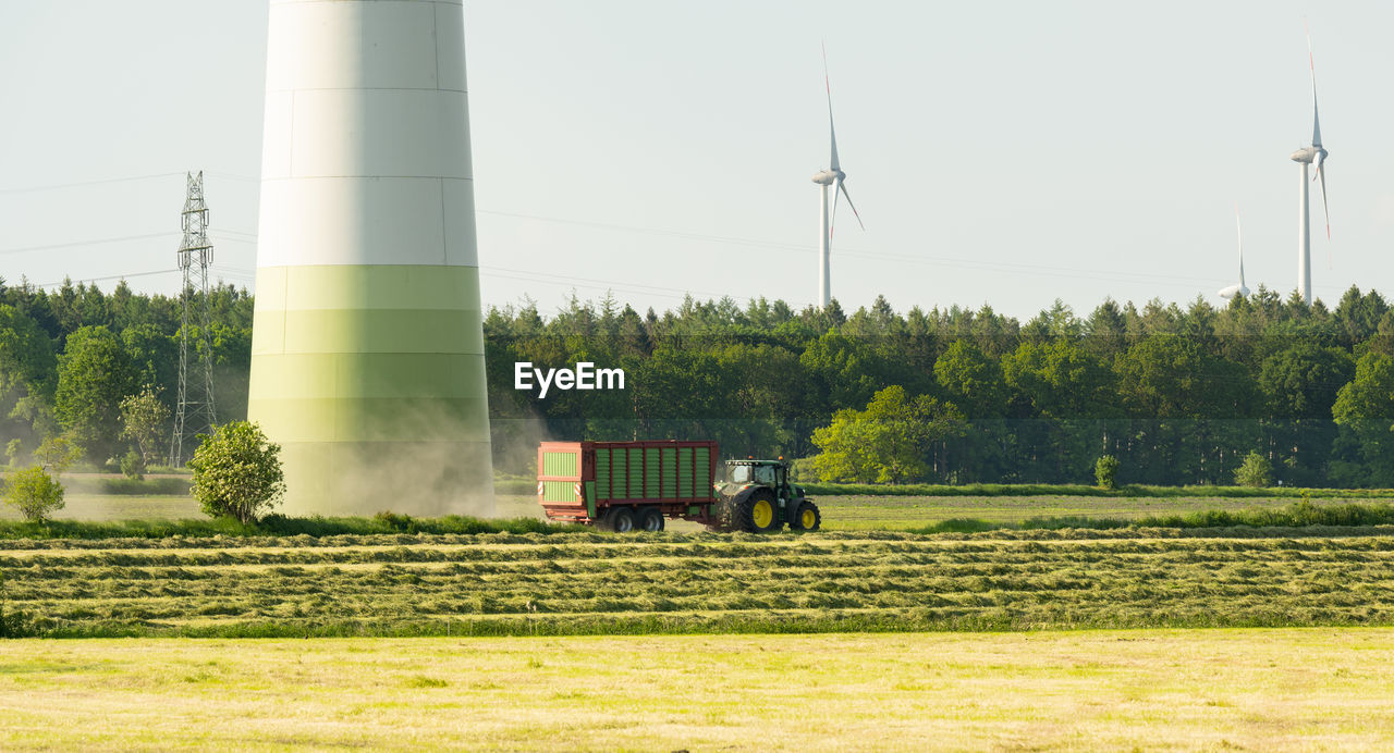 Tractor harvesting grass for the animal forage