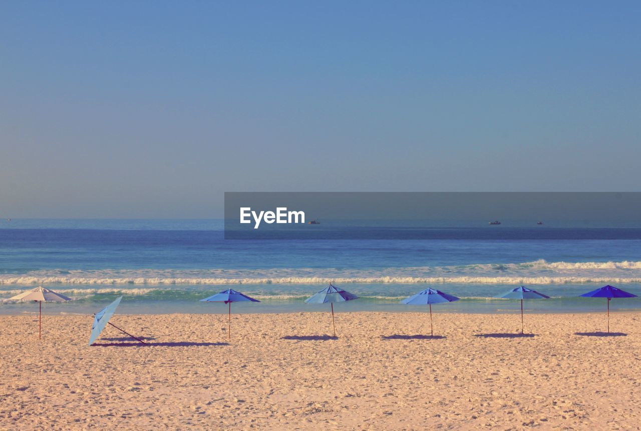 Scenic view of beach against clear sky