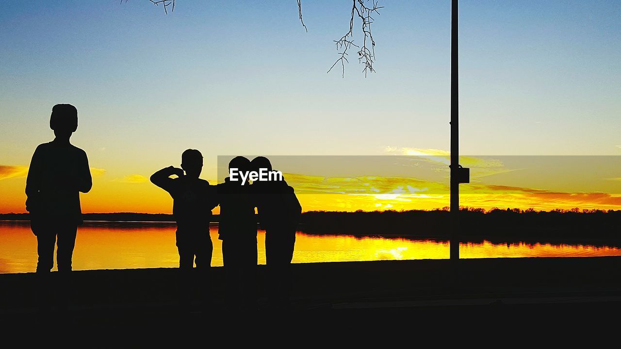 SILHOUETTE PEOPLE ON BEACH DURING SUNSET