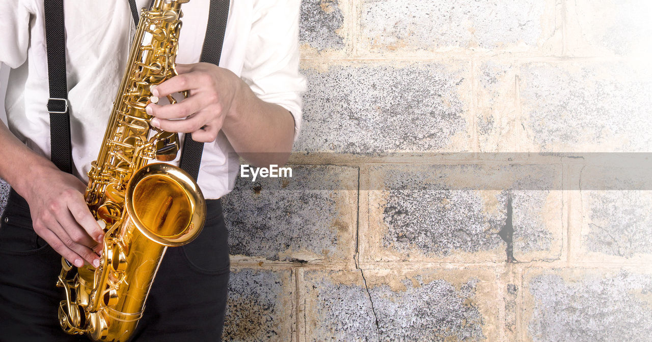 Young man in a white shirt with sax