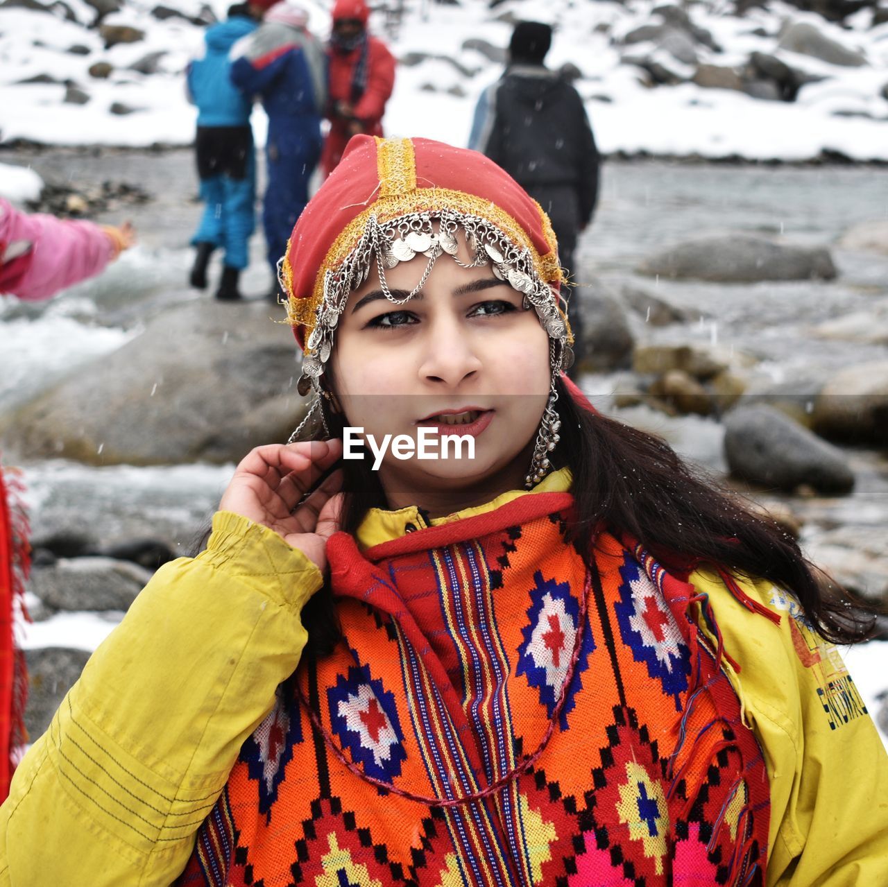 Young woman in traditional clothing standing outdoors