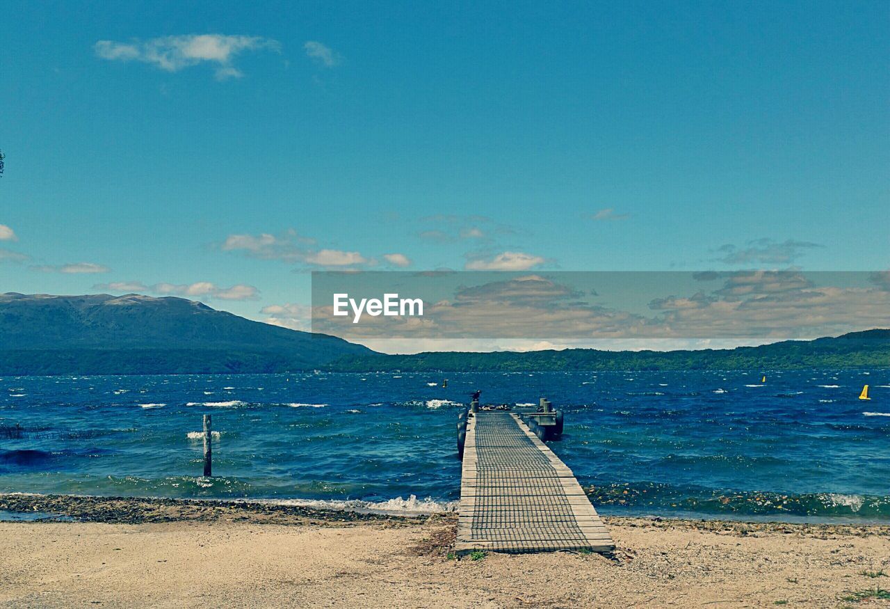 High angle view of jetty amidst sea against sky