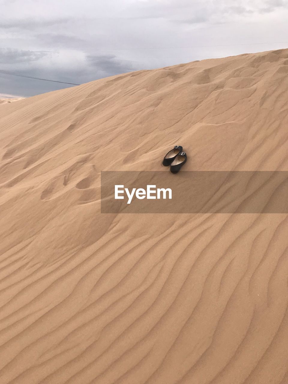 Sand dunes in desert against sky