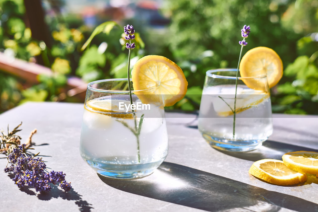 Cool lavender homemade lemonade with lemon slices and lavender flower. detox summer drink.