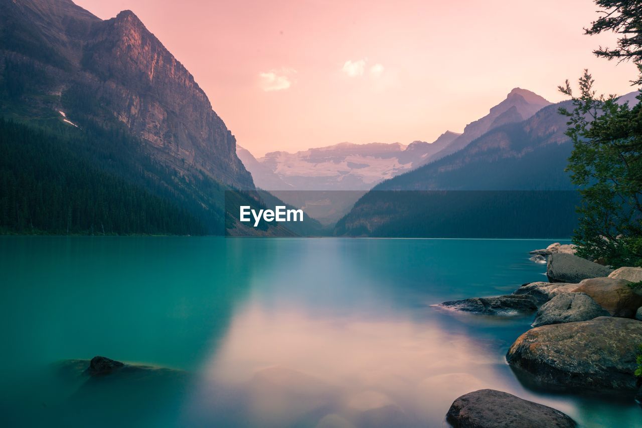 Scenic view of lake and mountains against sky