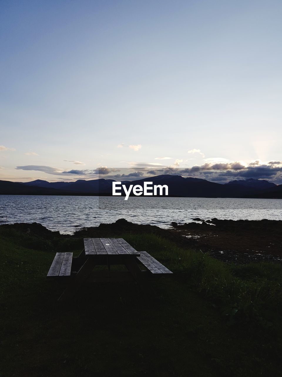 SCENIC VIEW OF BEACH AGAINST SKY AT SUNSET