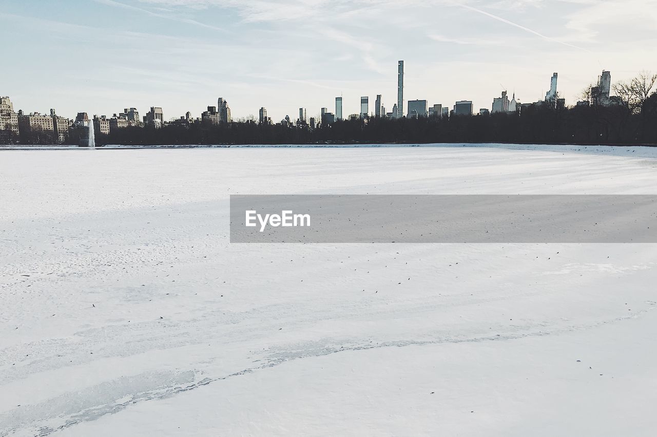 Scenic view of city against sky during winter