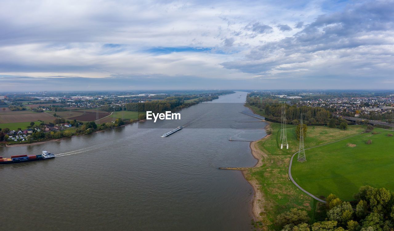 HIGH ANGLE VIEW OF RIVER AMIDST CITY