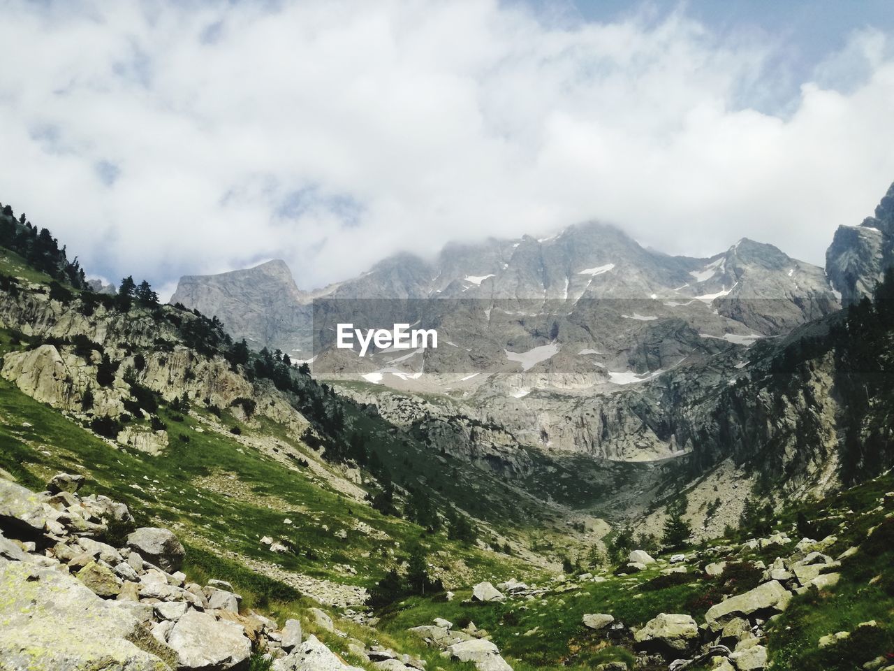 Scenic view of mountains against cloudy sky