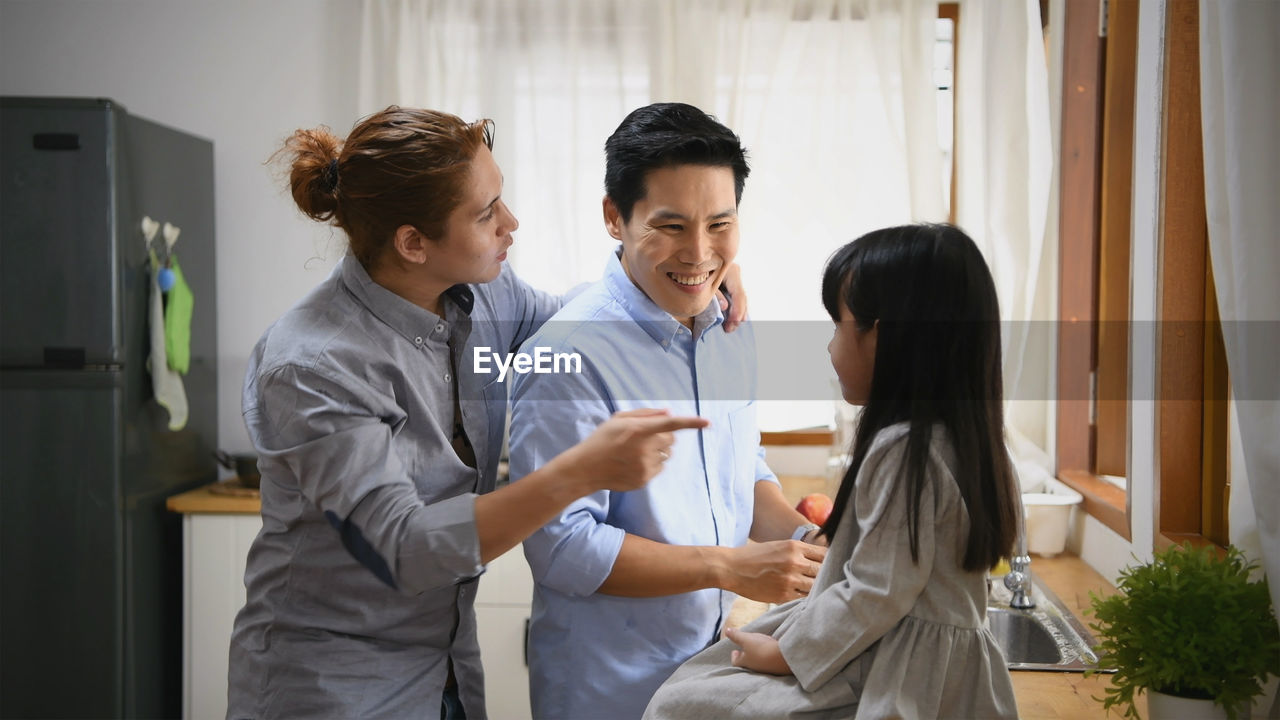 GROUP OF PEOPLE STANDING IN THE ROOM