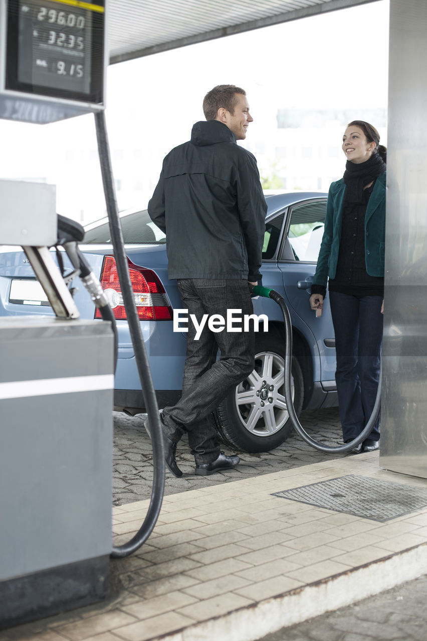 Man and woman at gas station