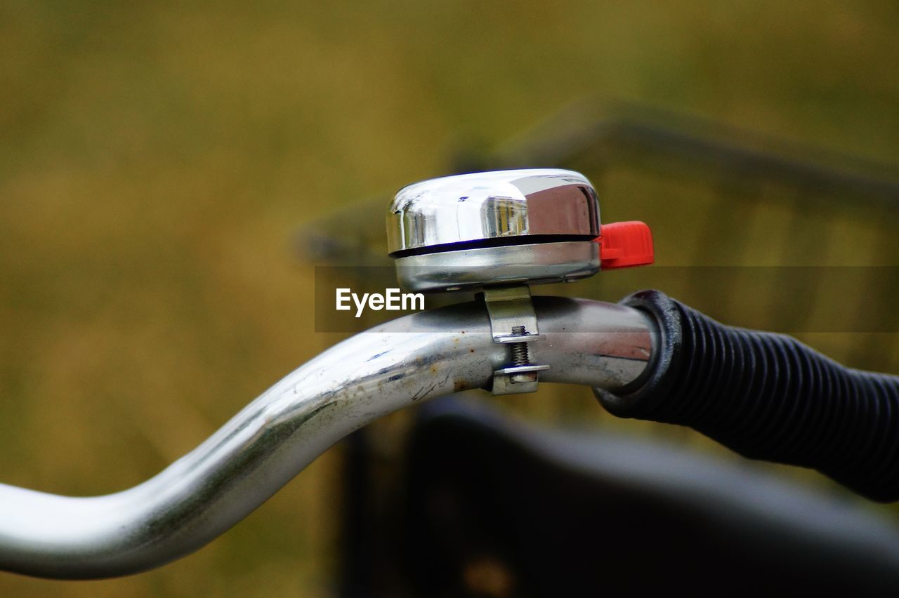 Close-up of bell on bicycle handlebar