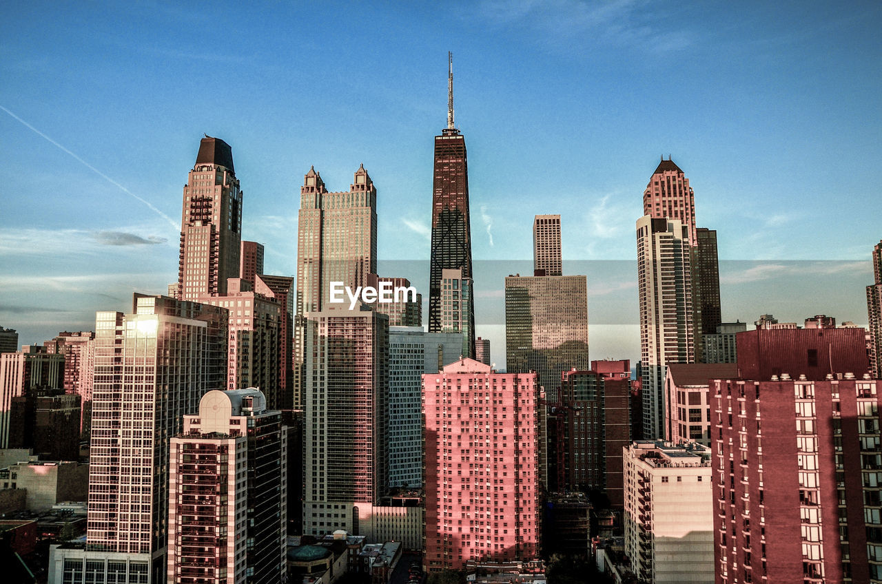 Modern buildings in city against sky