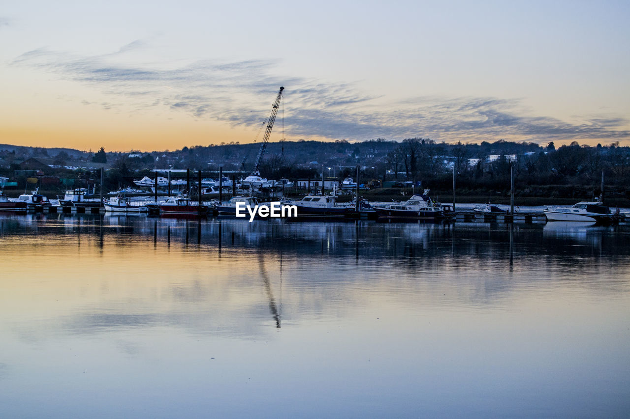 Boats moored at harbor