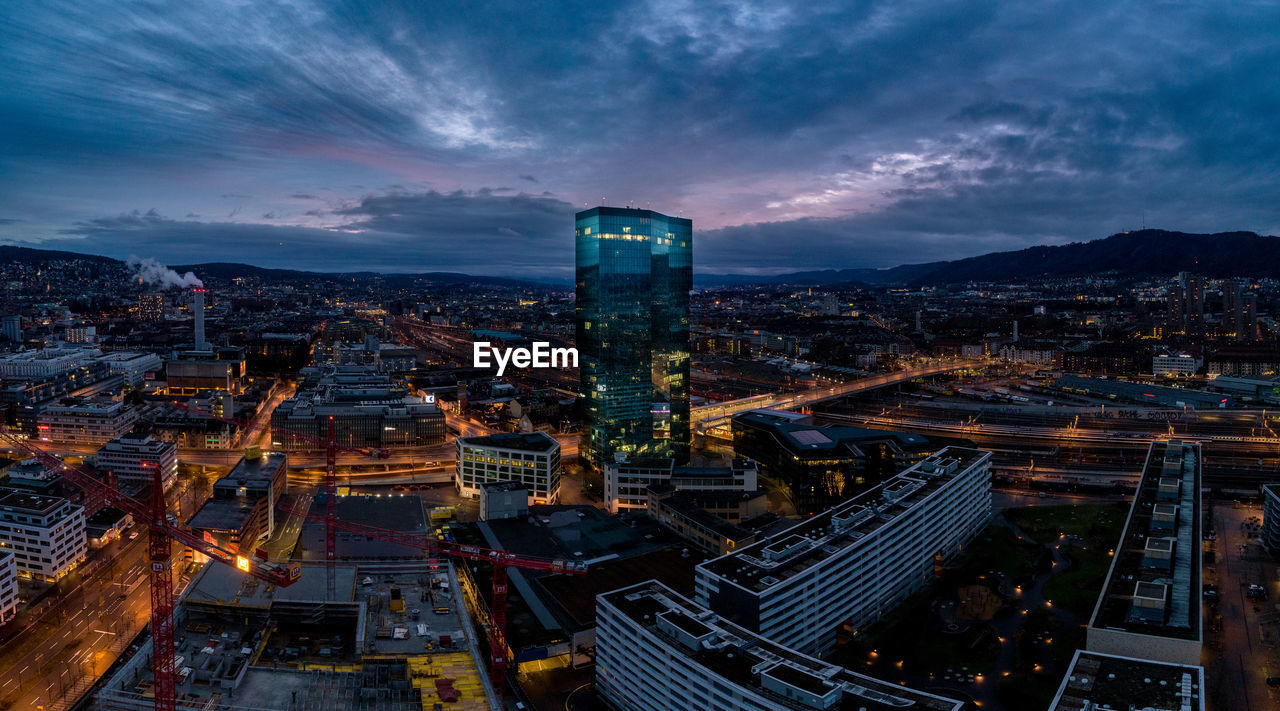 High angle view of illuminated city buildings at night