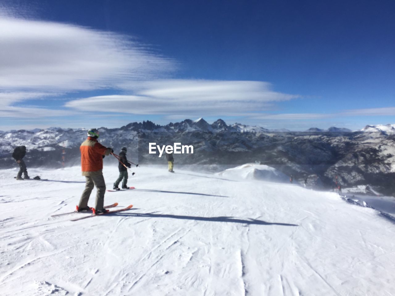 People skiing on snow covered field 