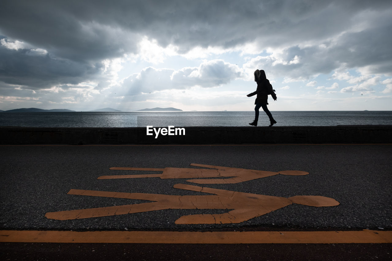 Woman walking in the park near the sea