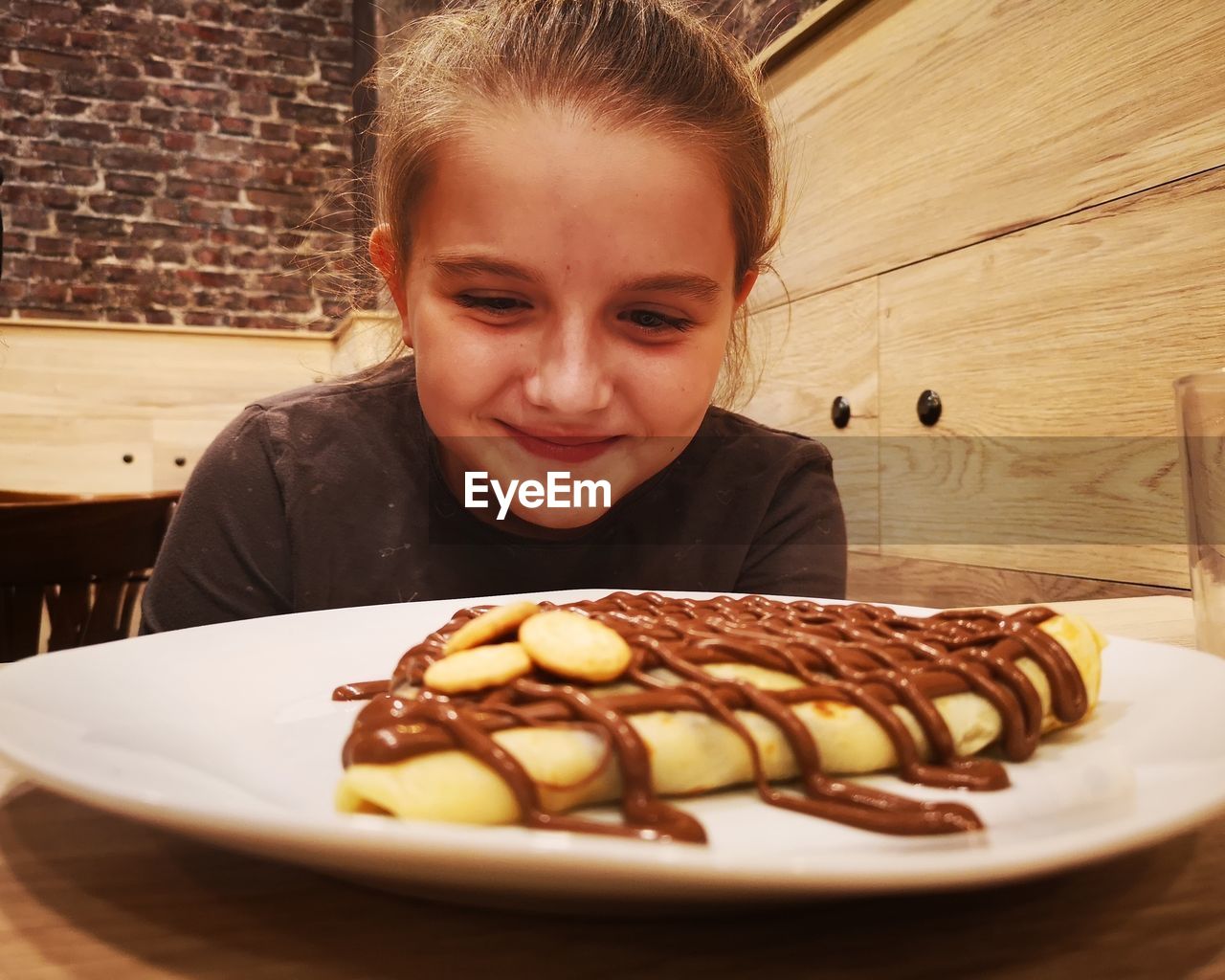 Girl looking at food on plate at restaurant 