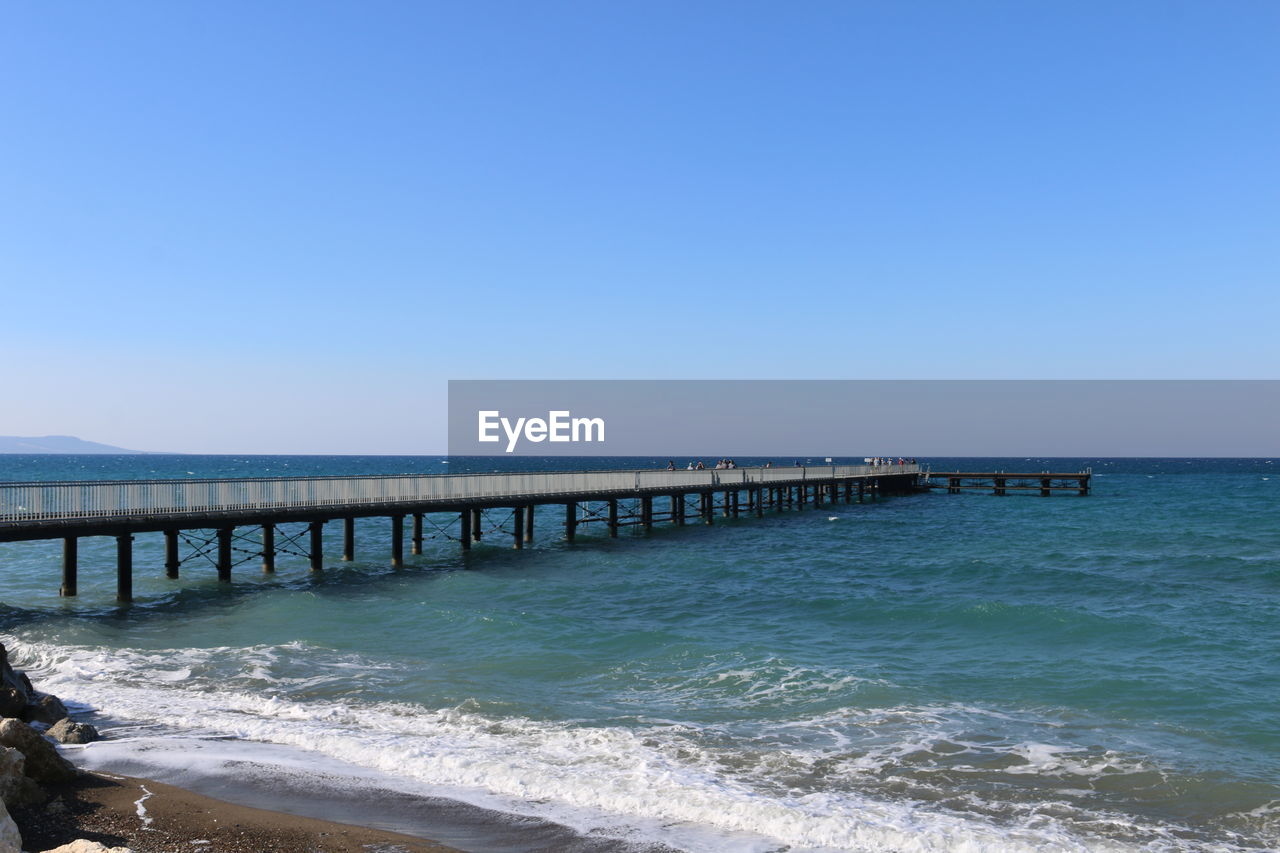 Scenic view of sea against clear blue sky