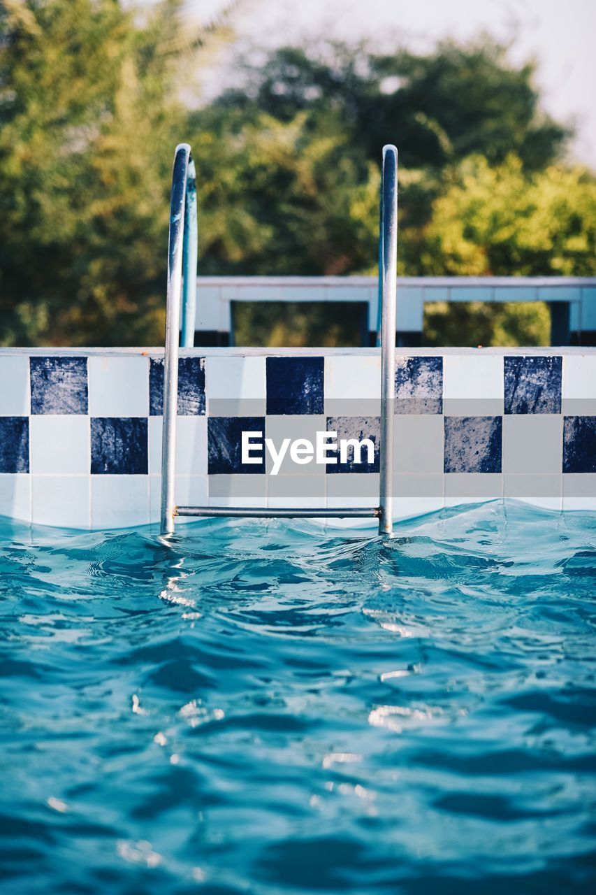 Close-up of swimming pool against trees