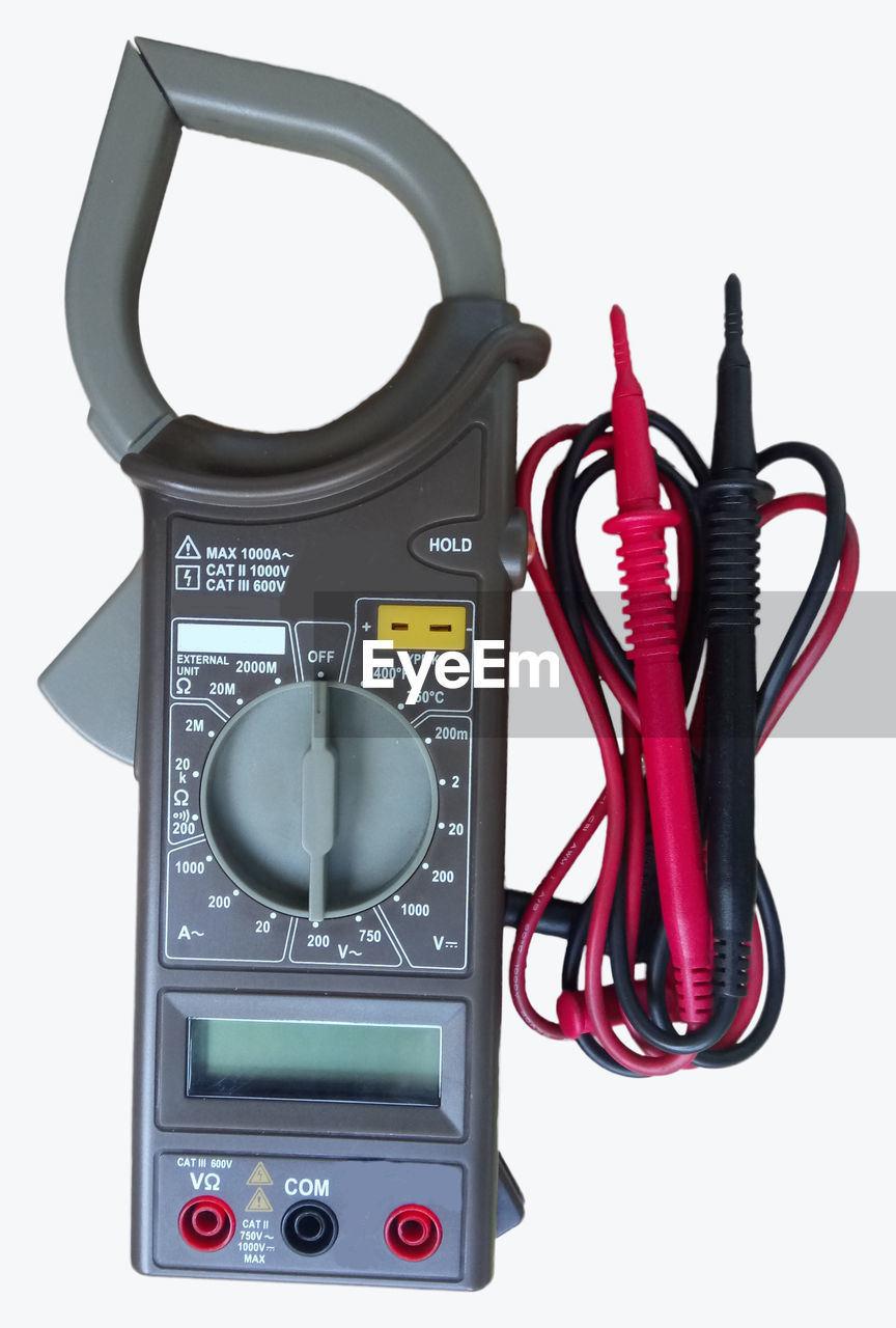 Close-up of multimeter against white background