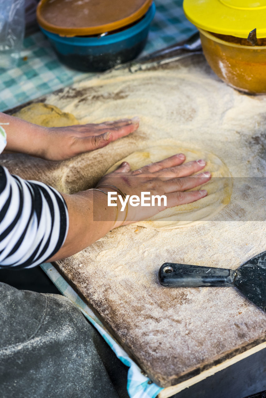 Cropped image of hand making flatbread