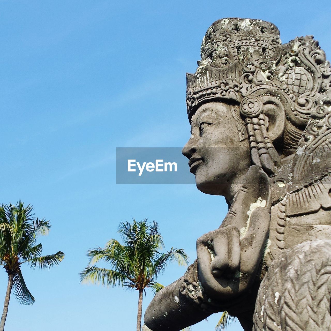 Low angle view of stone sculpture against sky at klungkung royal palace