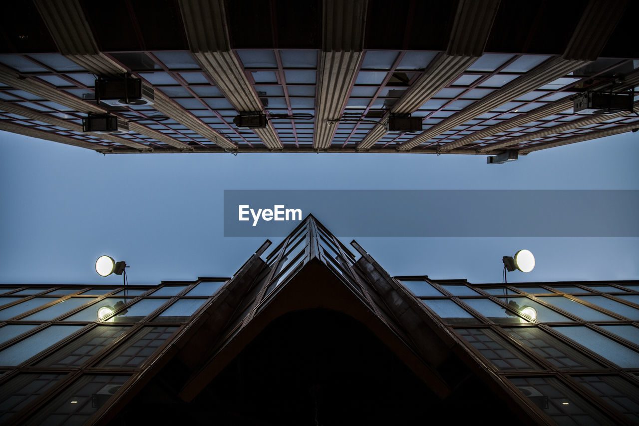 Low angle view of buildings against clear sky during sunset