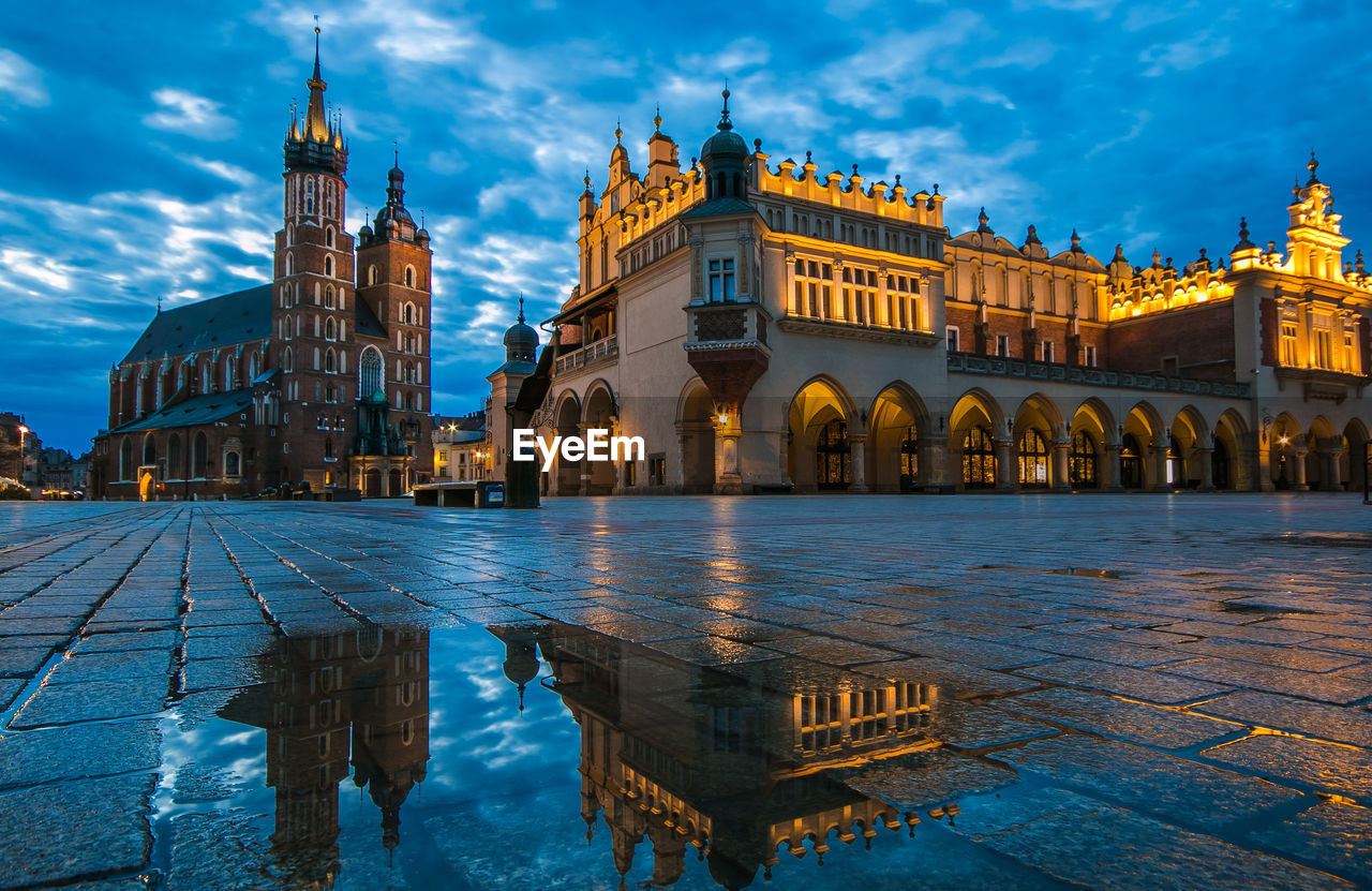 Illuminated building against sky in krakow city, poland