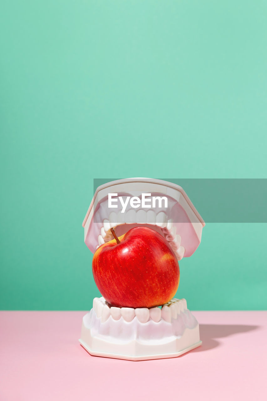 Ice cream cone on table against white background