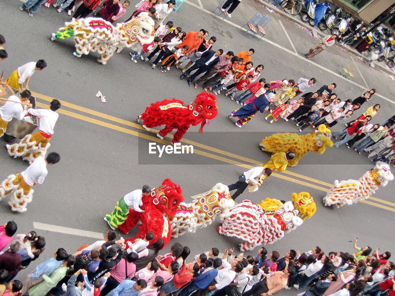 High angle view of dragon dancing amidst crowd on street during traditional festival