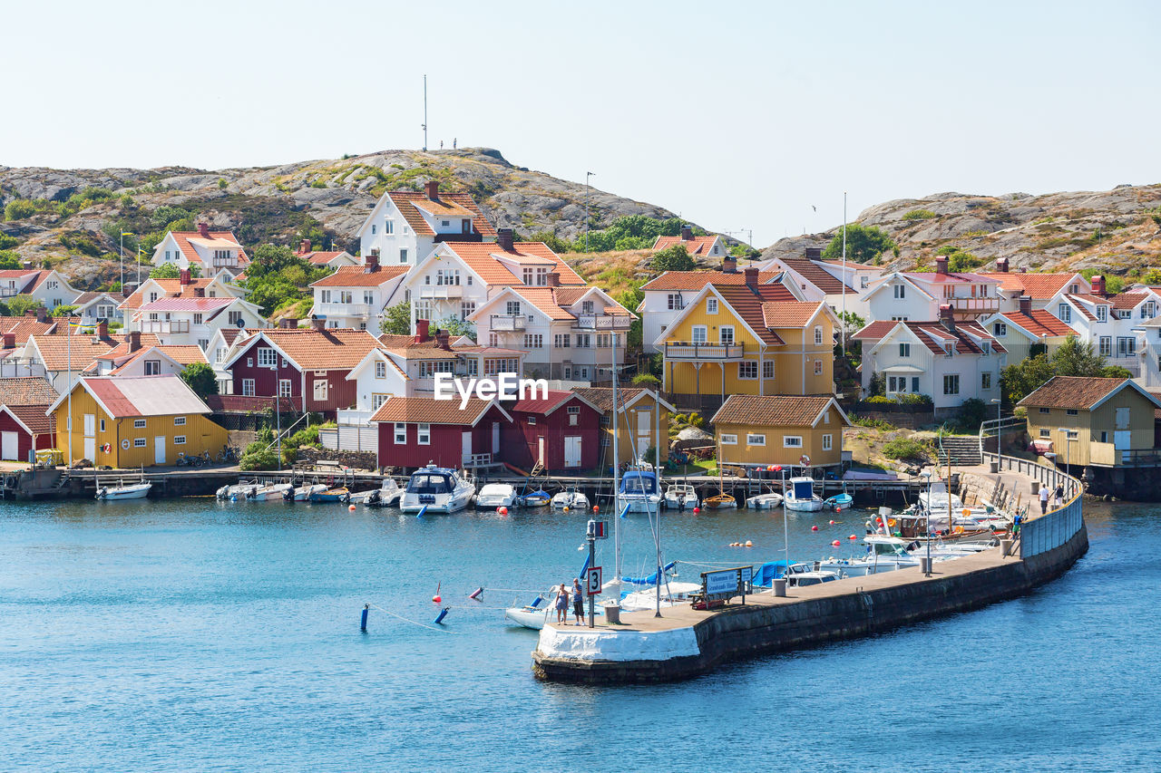 Townscape by sea against clear sky