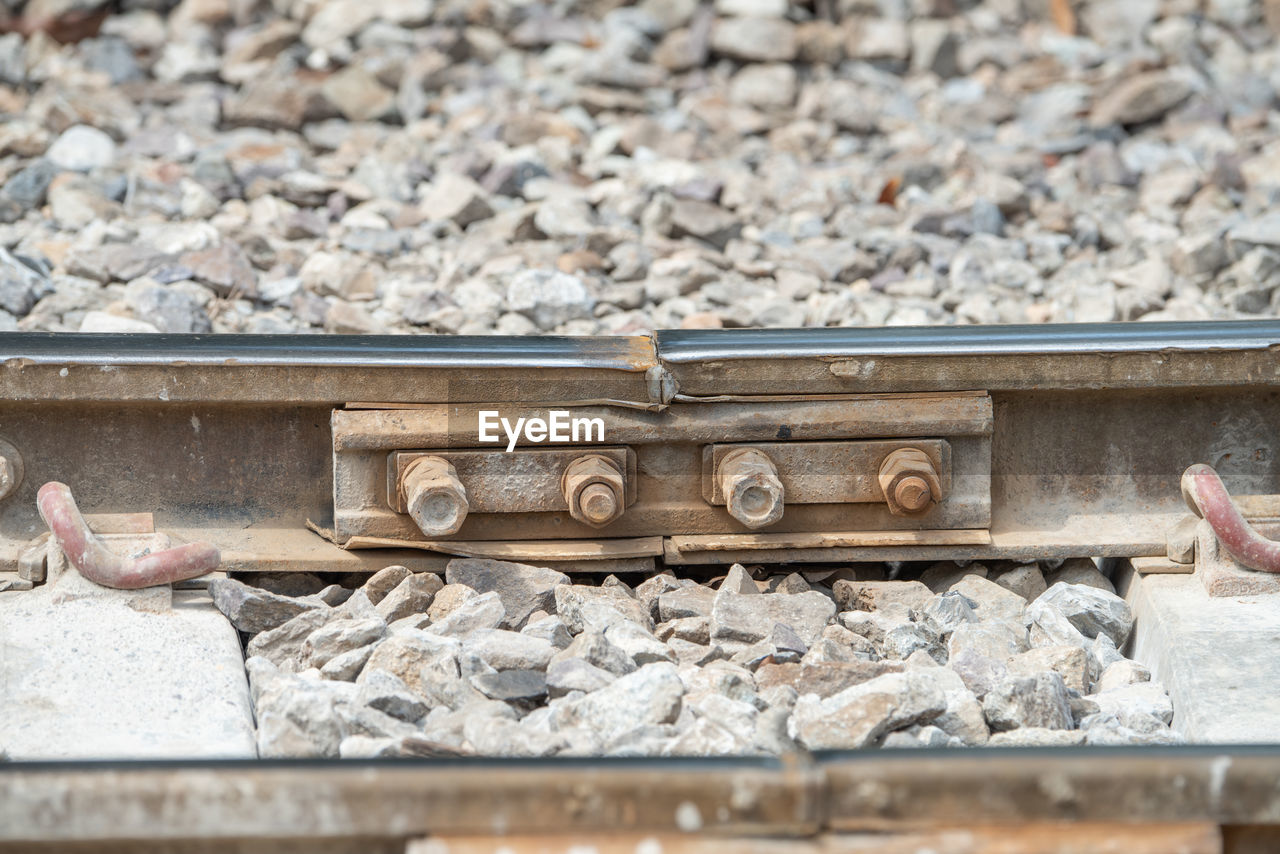 CLOSE-UP OF STONES ON RAILROAD TRACKS