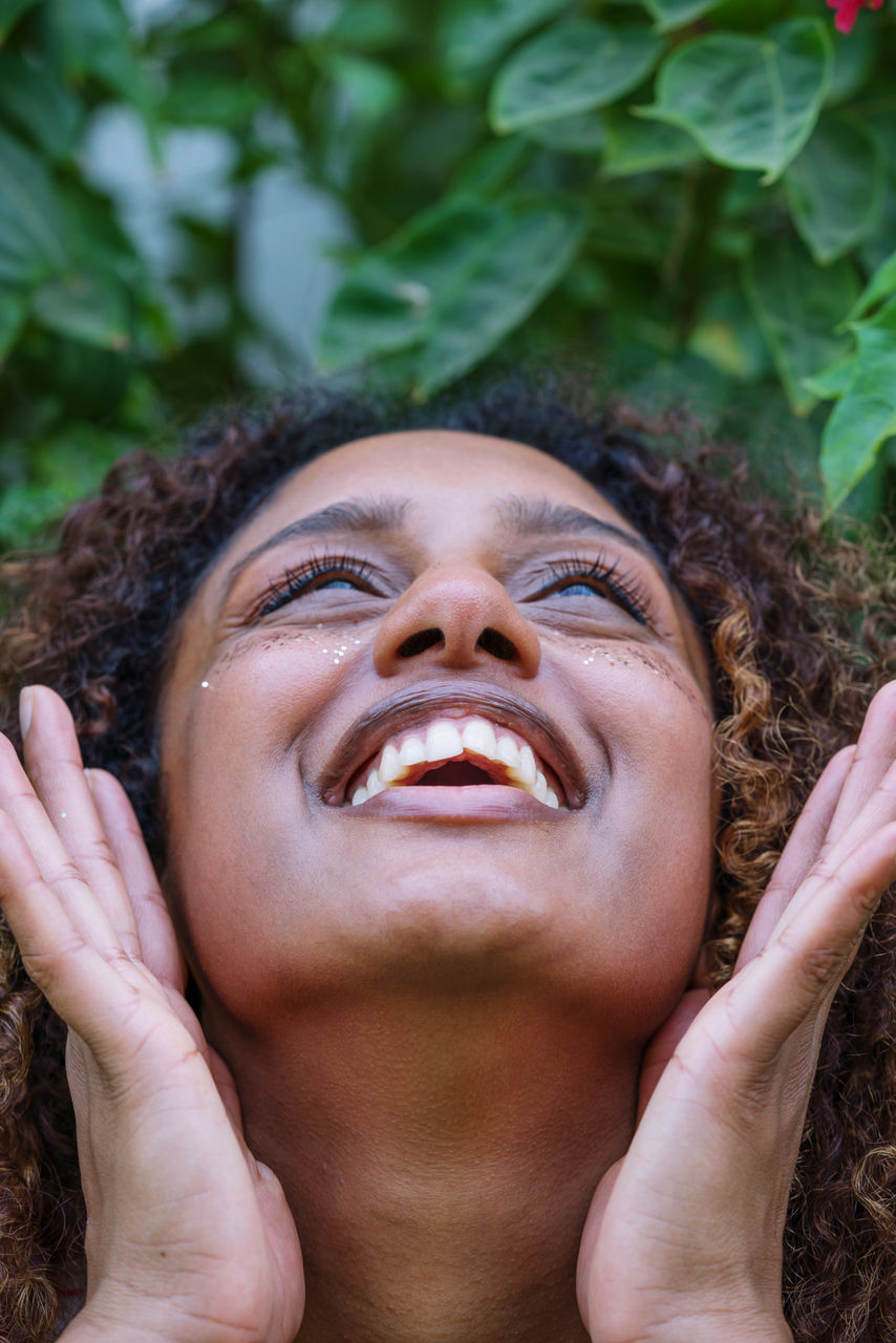 Portrait of a black woman with afro hair and glitter on her face