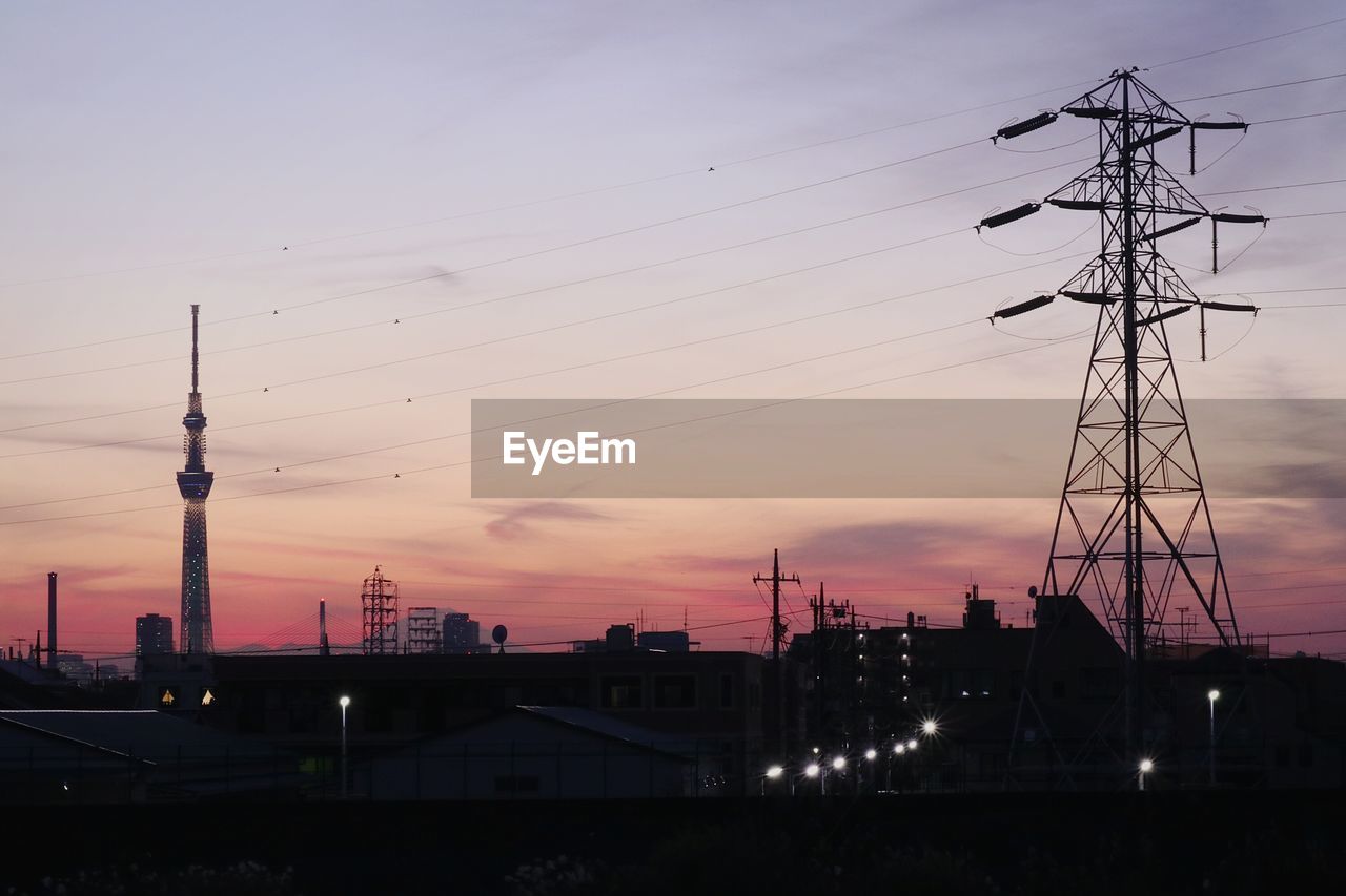 SILHOUETTE OF COMMUNICATIONS TOWER AT SUNSET