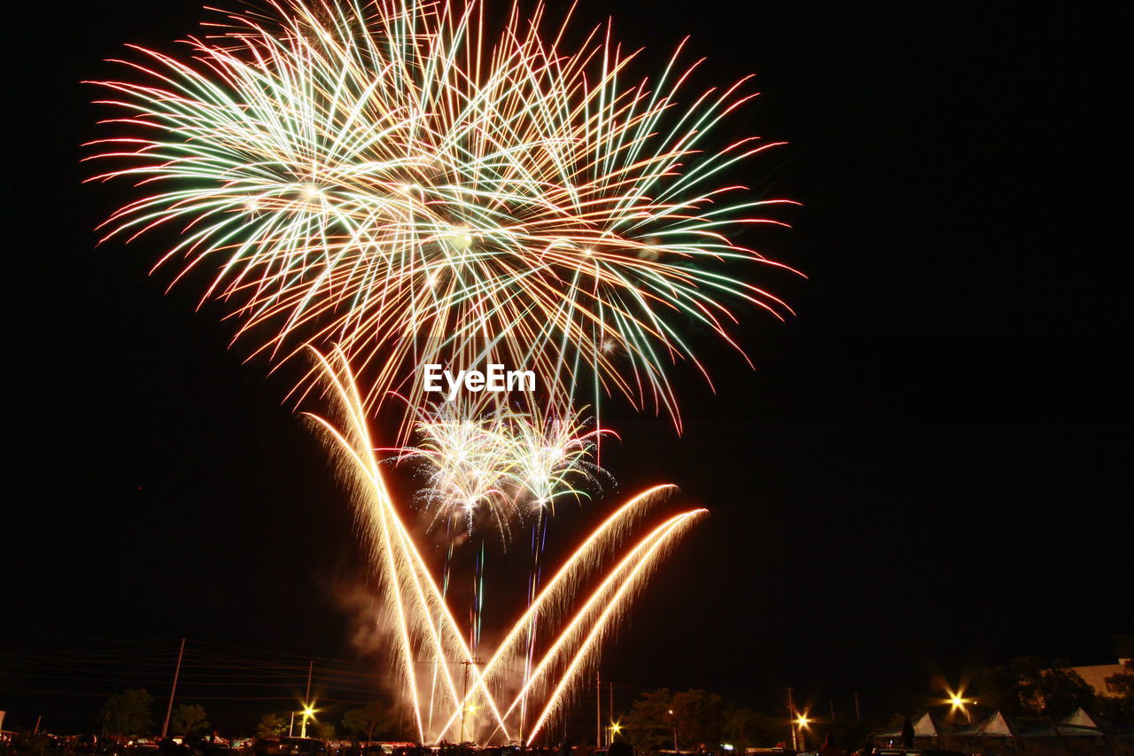 Low angle view of firework display at night