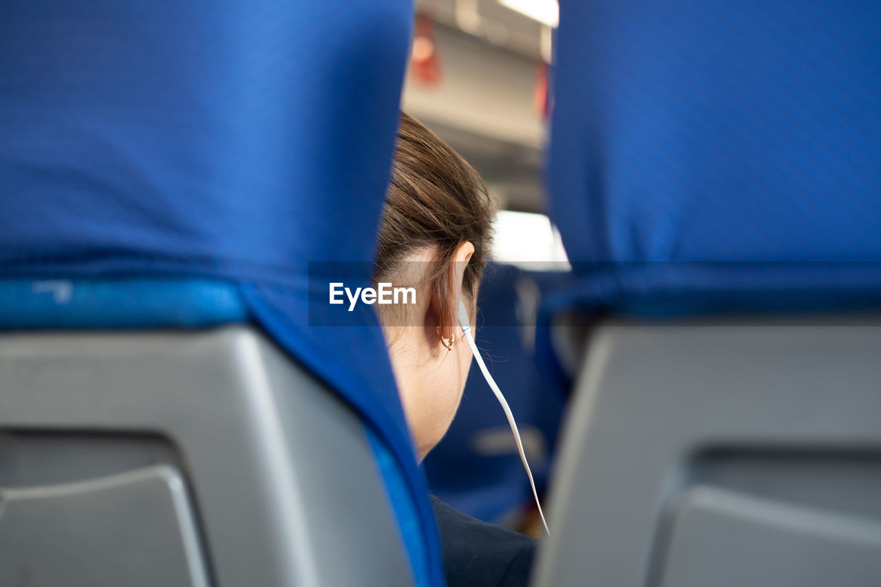 Woman listening music in airplane