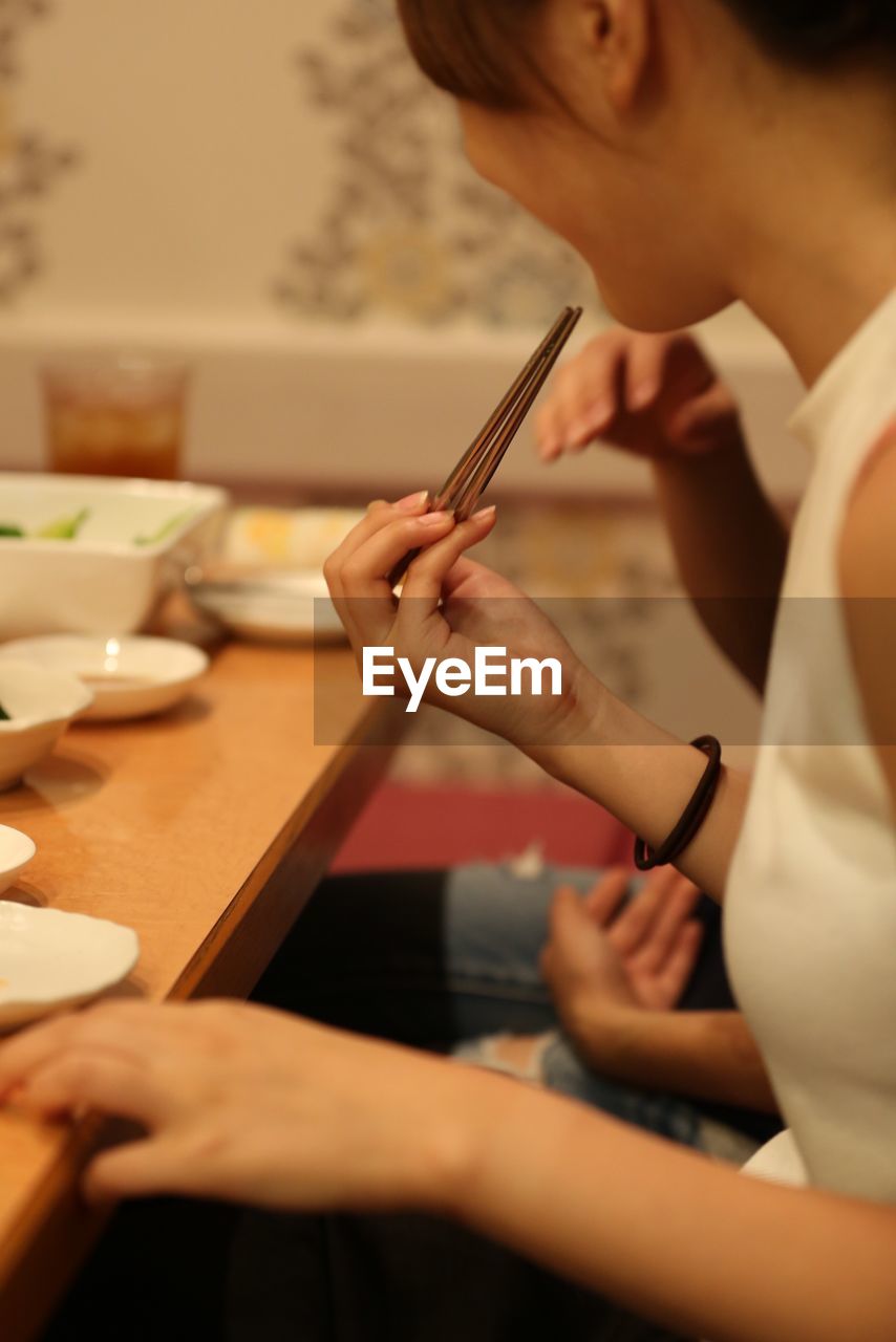 Close-up of woman working on table