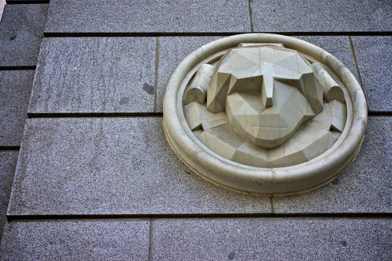 CLOSE-UP OF CIRCULAR OBJECT ON WALL